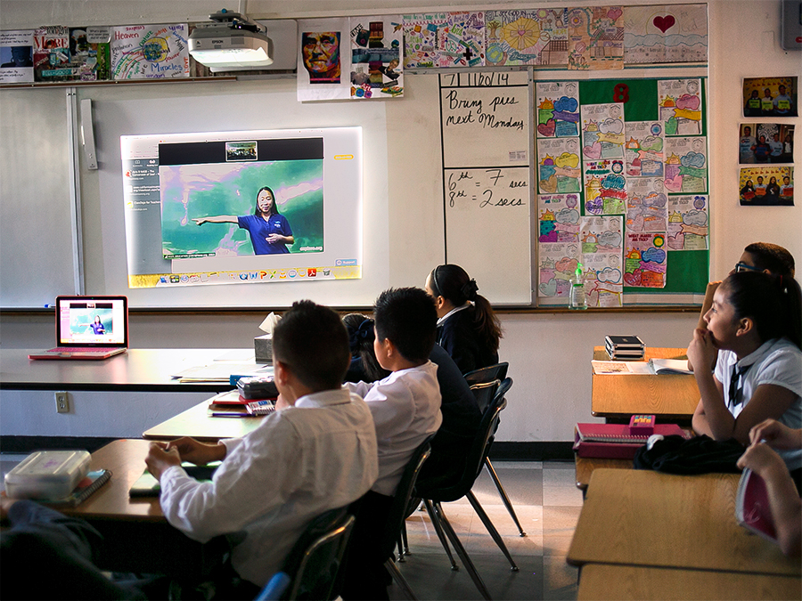 Students in a classroom watching Aquarium led video conference